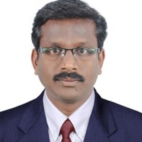 E Karunakaran, Phd