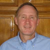 J R May