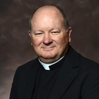 The Rev. Dr. John A. Krivak M.Ed., M. Phil.,  Ed.D., Ph.D.