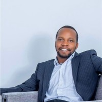 John Julius Muwulya, Assoc. Dbia